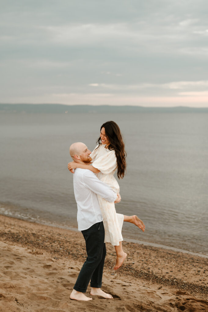 Sunrise couples photoshoot at park point beach in Duluth, Minnesota.